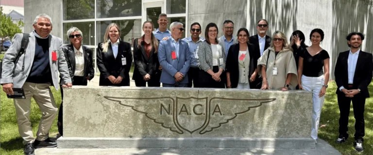 Group photo with Instream Energy at NACA monument outdoors.